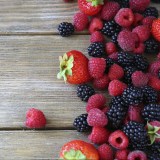 Summer berries on wooden background