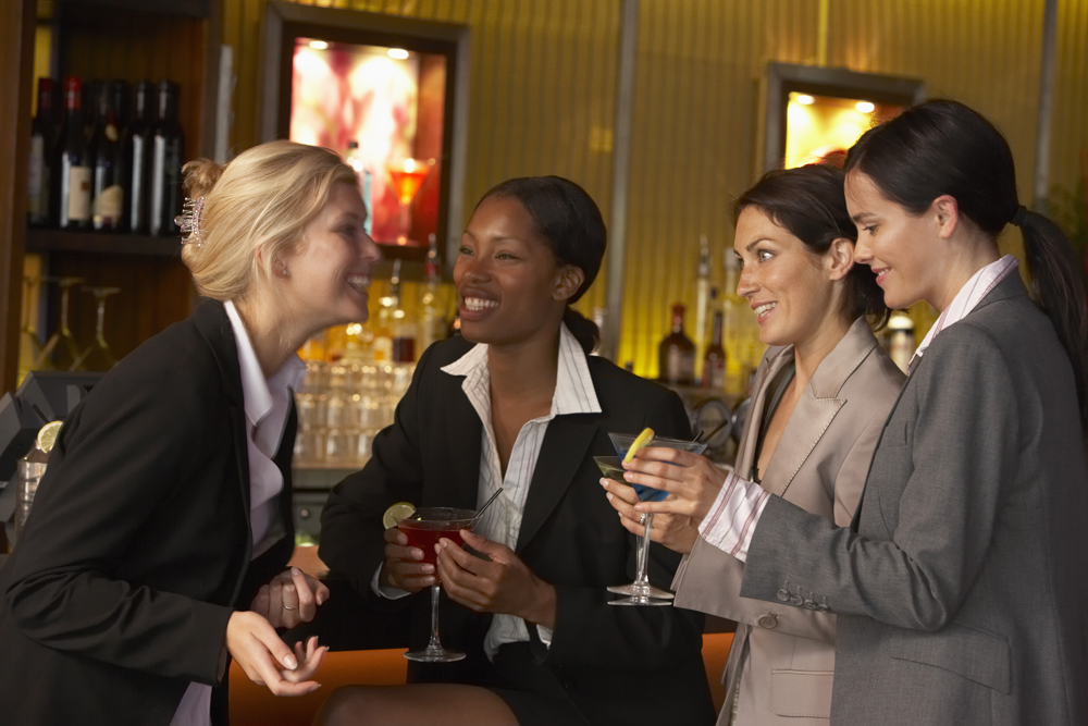 Businesswomen holding martinis