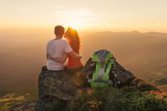 Happy couple enjoy beautiful view in the mountains