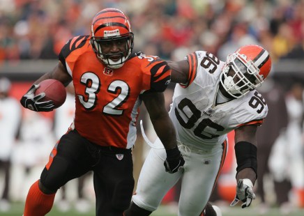 CINCINNATI - NOVEMBER 28: Running back Rudi Johnson #32 of the Cleveland Browns evades defensive end Kenard Lang #96 of the Cincinnati Bengals during the game at Paul Brown Stadium on November 28, 2004 in Cincinnati, Ohio. The Bengals defeated the Browns 58-48. (Photo by Andy Lyons/Getty Images)