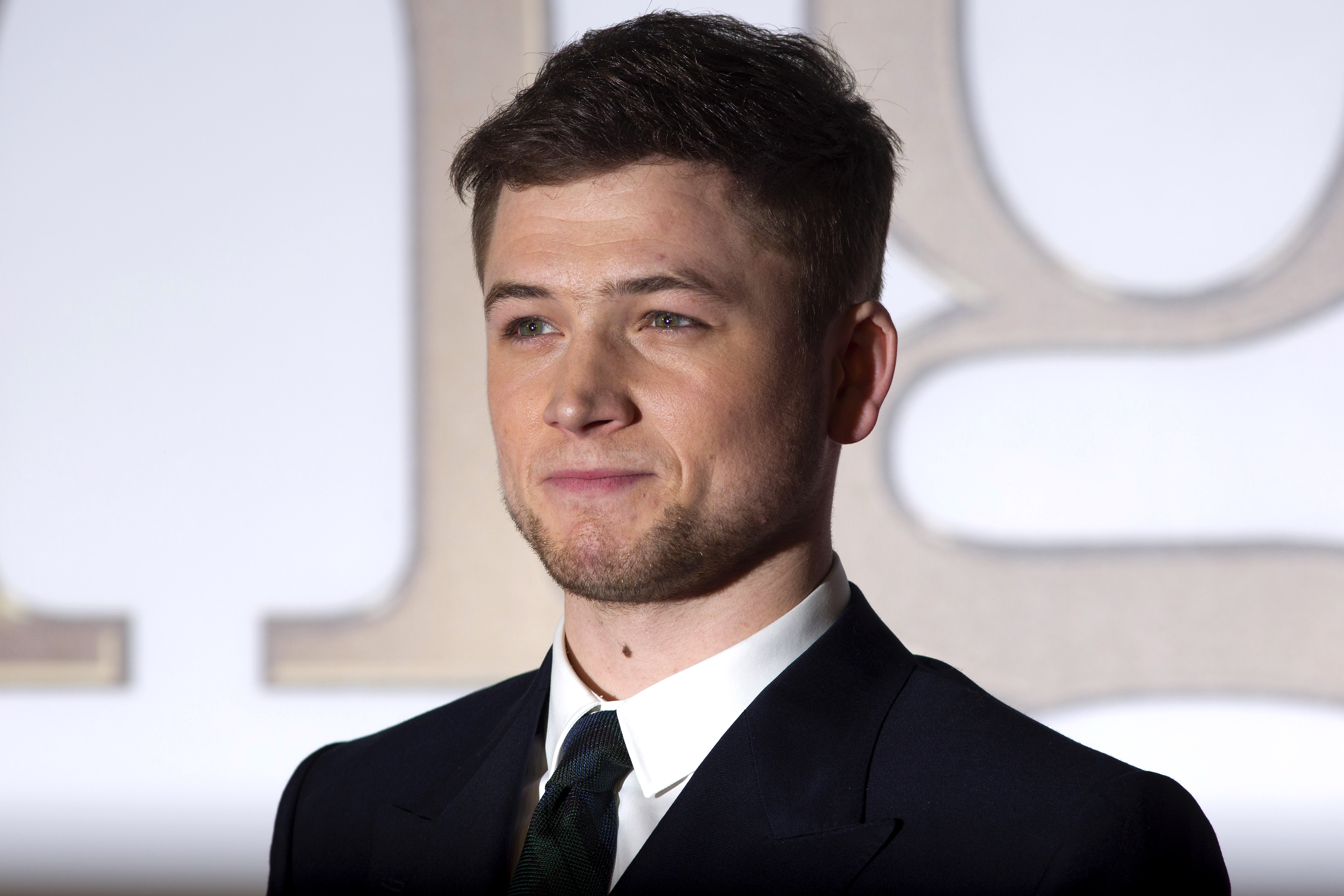 British actor Taron Egerton poses for pictures on the red carpet as he arrives to attend the world premier of "Kingsman, The Secret Service" in central London on January 14, 2015. AFP PHOTO / JUSTIN TALLIS