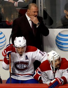 Montreal Canadiens head coach Michel Therrien, top, right wing Brendan Gallagher (11) and center Tomas Plekanec (14) react as they watch players during the third period of an NHL hockey game against the Chicago Blackhawks Sunday, Jan. 17, 2016, in Chicago. The Blackhawks won 5-2. (AP Photo/Nam Y. Huh)