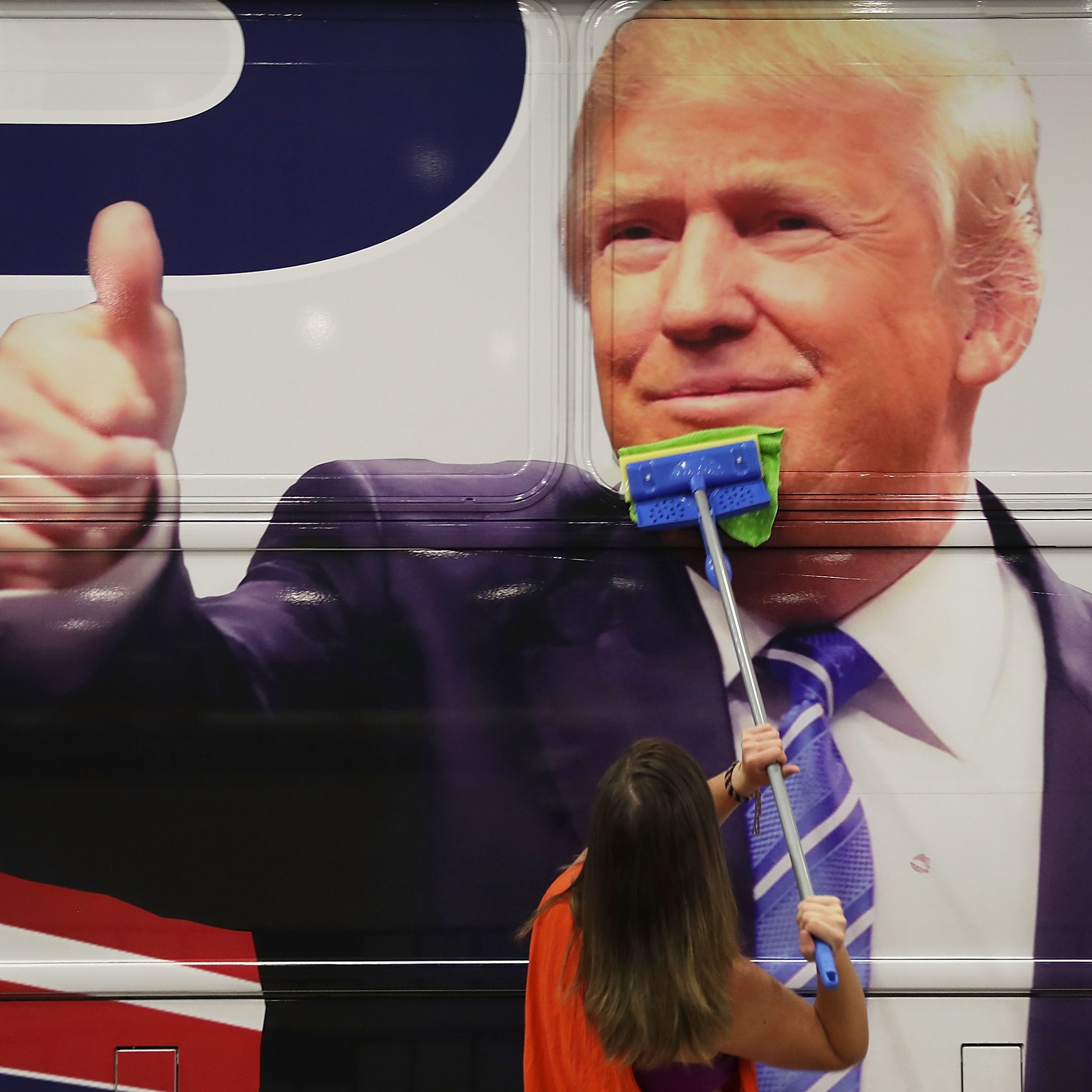 WEST PALM BEACH, FL - OCTOBER 13: Bailey McDaniel wipes off the side of the campaign bus of Republican presidential candidate Donald Trump before his campaign rally at the South Florida Fair Expo Center on October 13, 2016 in West Palm Beach, Florida. Trump continues to campaign against Democratic presidential candidate Hillary Clinton with less than one month to Election Day. (Photo by Joe Raedle/Getty Images)