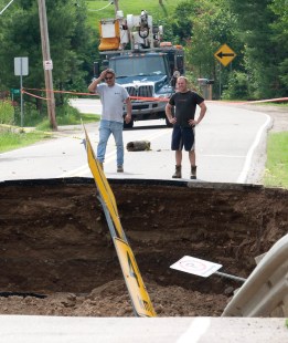Hydro Quebec workers survey the scene where a section of road on a causeway collapsed following an earthquake in Bowman, Quebec Wednesday June 23, 2010. THE CANADIAN PRESS/Adrian Wyld