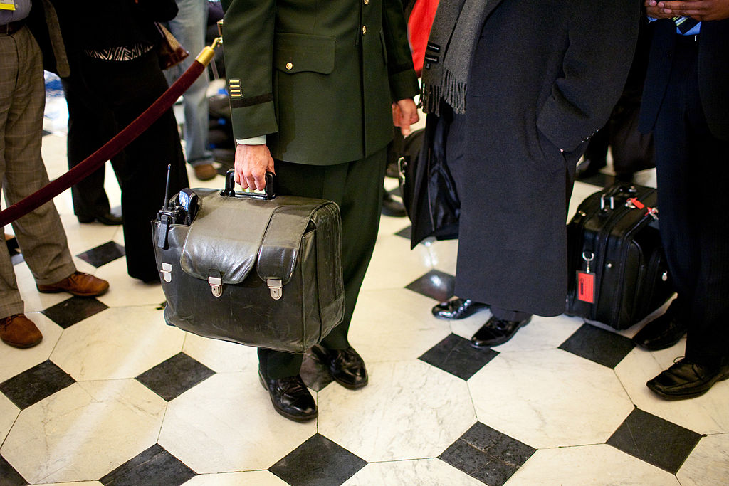 WASHINGTON - FEBRUARY 24: A military aide carries the nuclear football, with the nation's nuclear launch codes, through Statuary Hall as President Barack Obama arrives at the U.S. Capitol for his address to a joint session of Congress on February 24, 2009 in Washington, DC. U.S. President Barack Obama will address a joint session of the Congress at 9:01pm tonight where he plans to address the topics of the struggling U.S. economy, the budget deficit, and health care. (Photo by Brendan Hoffman/Getty Images)