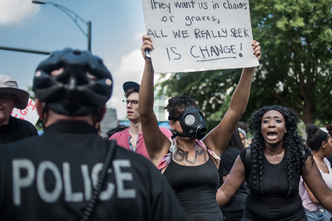 CHARLOTTE, NC - SEPTEMBER 25: Demonstrators protest outside of Bank of America Stadium before an NFL football game between the Charlotte Panthers and the Minnesota Vikings September 25, 2016 in Charlotte, North Carolina.. Protests have disrupted the city since Tuesday night following the shooting of 43-year-old Keith Lamont Scott at an apartment complex near UNC Charlotte. (Photo by Sean Rayford/Getty Images)
