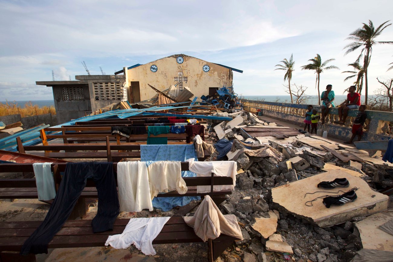 Residents dry clothes at a church that was destroyed by Hurricane Matthew in Jeremie, Haiti, Sunday, Oct. 9, 2016. Jeremie appears to be the epicenter of the country's growing humanitarian crisis in the wake of the storm. ( AP Photo/Dieu Nalio Chery)