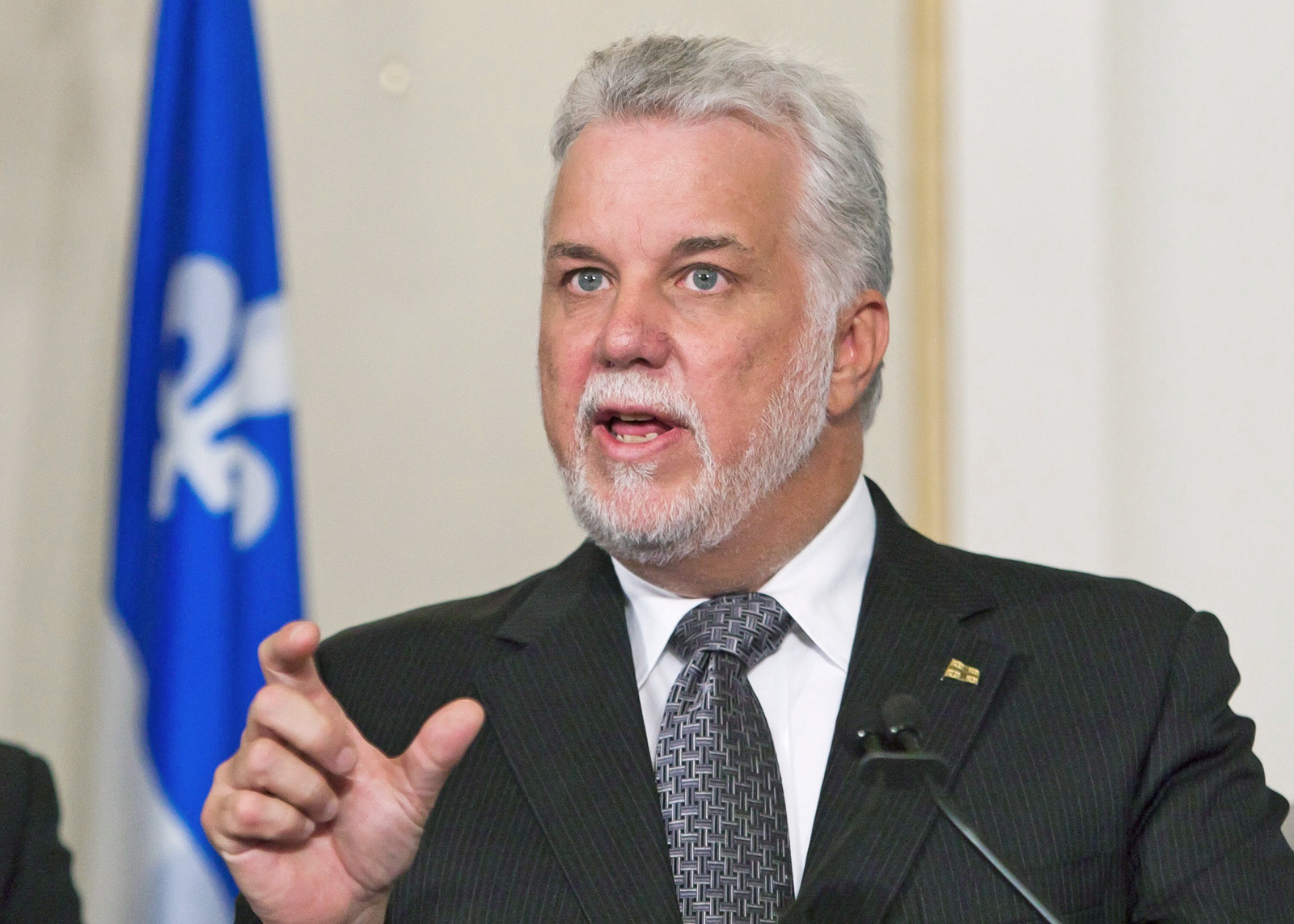 Quebec Premier Philippe Couillard gestures during a news conference after a cabinet shuffle at the legislature in Quebec City on Saturday, August 20, 2016. THE CANADIAN PRESS/Clement Allard