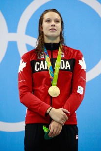 RIO DE JANEIRO, BRAZIL - AUGUST 11: Gold medalist Penny Oleksiak of Canada celebrates on the podium during the medal ceremony for the Women's 100m Freestyle Final on Day 6 of the Rio 2016 Olympic Games at the Olympic Aquatics Stadium on August 11, 2016 in Rio de Janeiro, Brazil. (Photo by Adam Pretty/Getty Images)