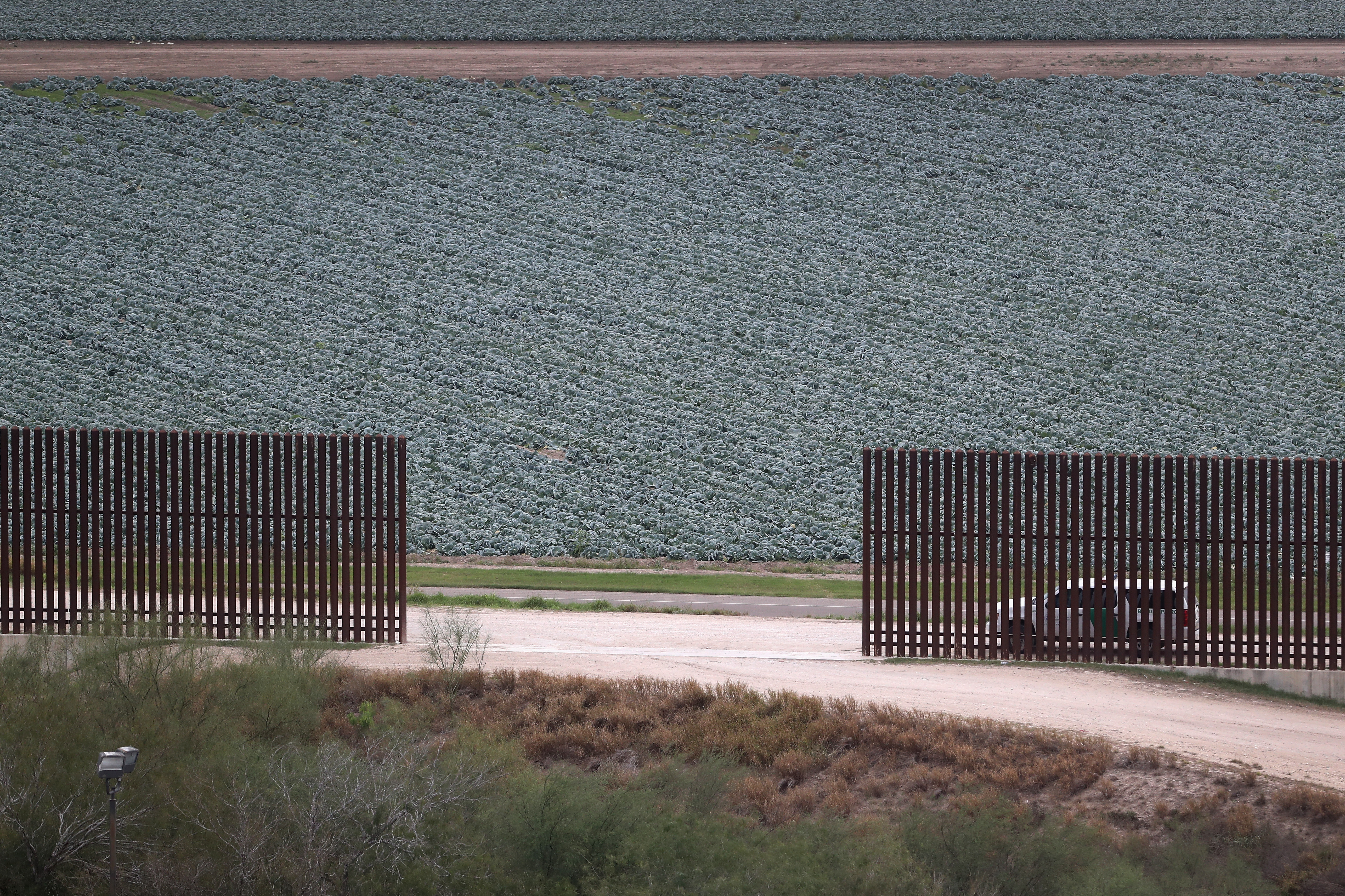 MCALLEN, TX - JANUARY 05: A U.S. Border Patrol vehicle sits waiting for illegal immigrants at a fence opening near the U.S.-Mexico border on January 5, 2017 near McAllen, Texas. The number of incoming immigrants has surged ahead of the upcoming Presidential inauguration of Donald Trump, who has pledged to build a wall along the U.S.-Mexico border. (Photo by John Moore/Getty Images)