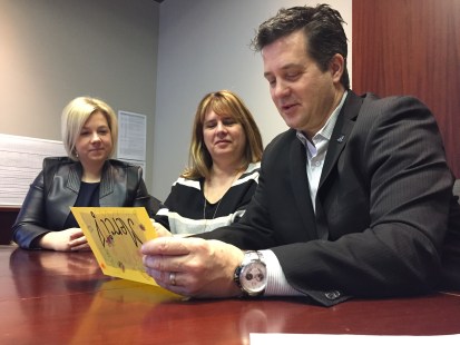 Le maire de Montréal-Est, Robert Coutu, lit un message accompagnant le dollar symbolique payé par les dirigeantes du CPE Tante Michèle, Manon Brodeur et Kathleen Lamothe, pour l’acquisition d’un terrain., le 20 janvier 2017.