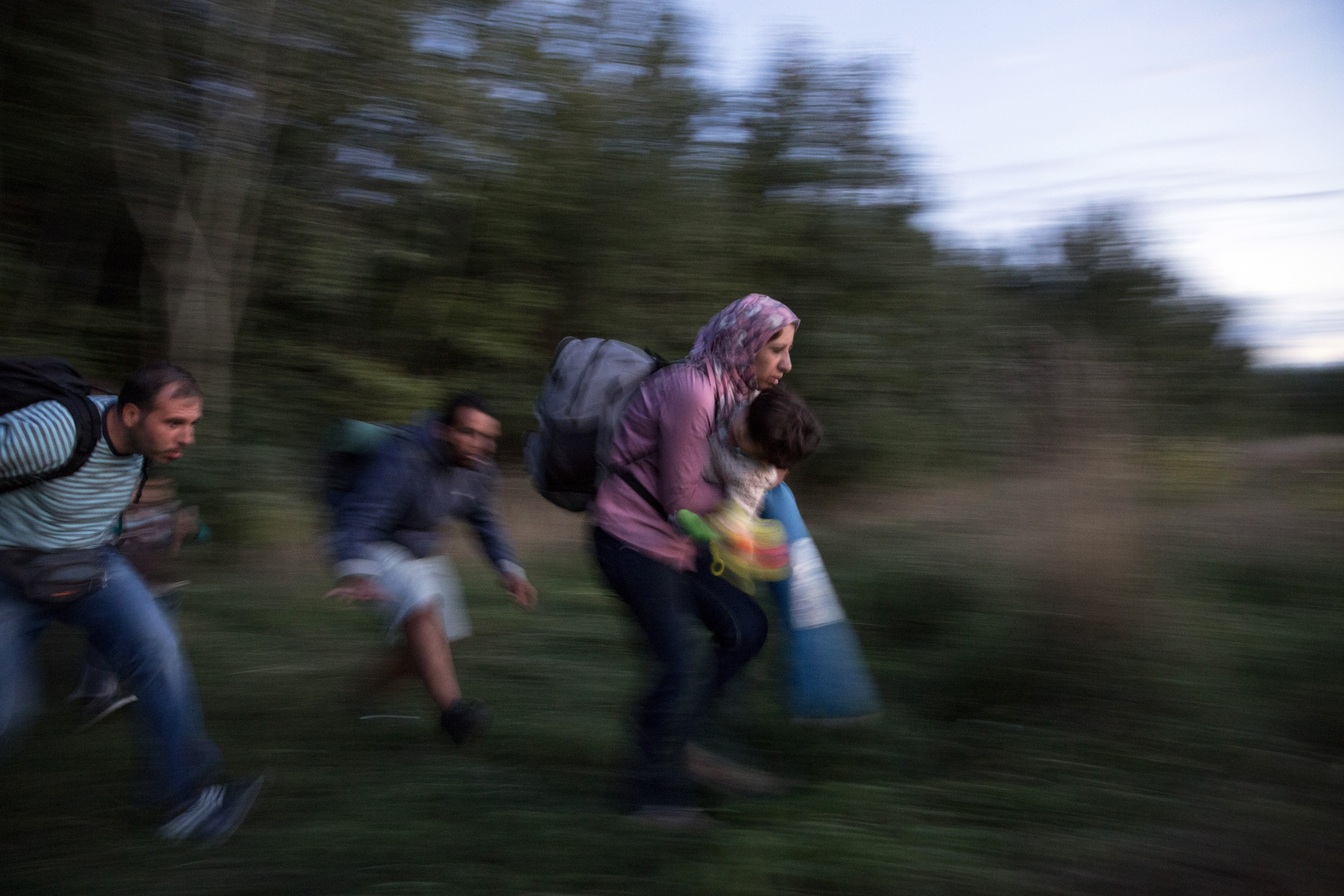 ROSZKE, HUNGARY - SEPTEMBER 08: Refugees are smuggled through fields and forests in an attempt to evade the Hungarian police close to the Serbian border on September 8, 2015 in Roszke, Hungary. Many migrants fear that if they are forced to officially register and have their fingerprints taken, it will stop them being able to move freely out of Hungary and further into Europe. A lack of clarity on the issue is causing many people to risk being arrested unnecessarily by taking such measures. Thousands of migrants have continued to cross into Hungary over the last few days from Serbia. Since the beginning of 2015 the number of migrants using the so-called 'Balkans route' has exploded with migrants arriving in Greece from Turkey and then travelling on through Macedonia and Serbia before entering the EU via Hungary. The number of people leaving their homes in war torn countries such as Syria, marks the largest migration of people since World War II. (Photo by Dan Kitwood/Getty Images)