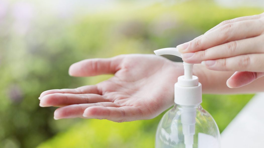Une personne se lave les mains avec des produits désinfectants, du gel hydroalcoolique.