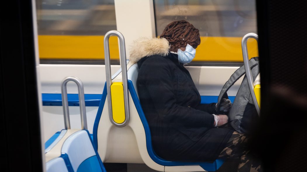 Une dame porte un masque dans le métro.
