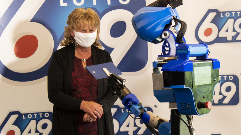 Covid-19 oblige, c’est le robot SARA de l'ÉTS qui s’est occupé de remettre le gros lot de Loto-Québec. ÉTS Walking Machine SARA gros lot Lot-Québec