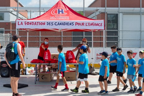 Des jeunes attendent en ligne avant de recevoir leur trousse.