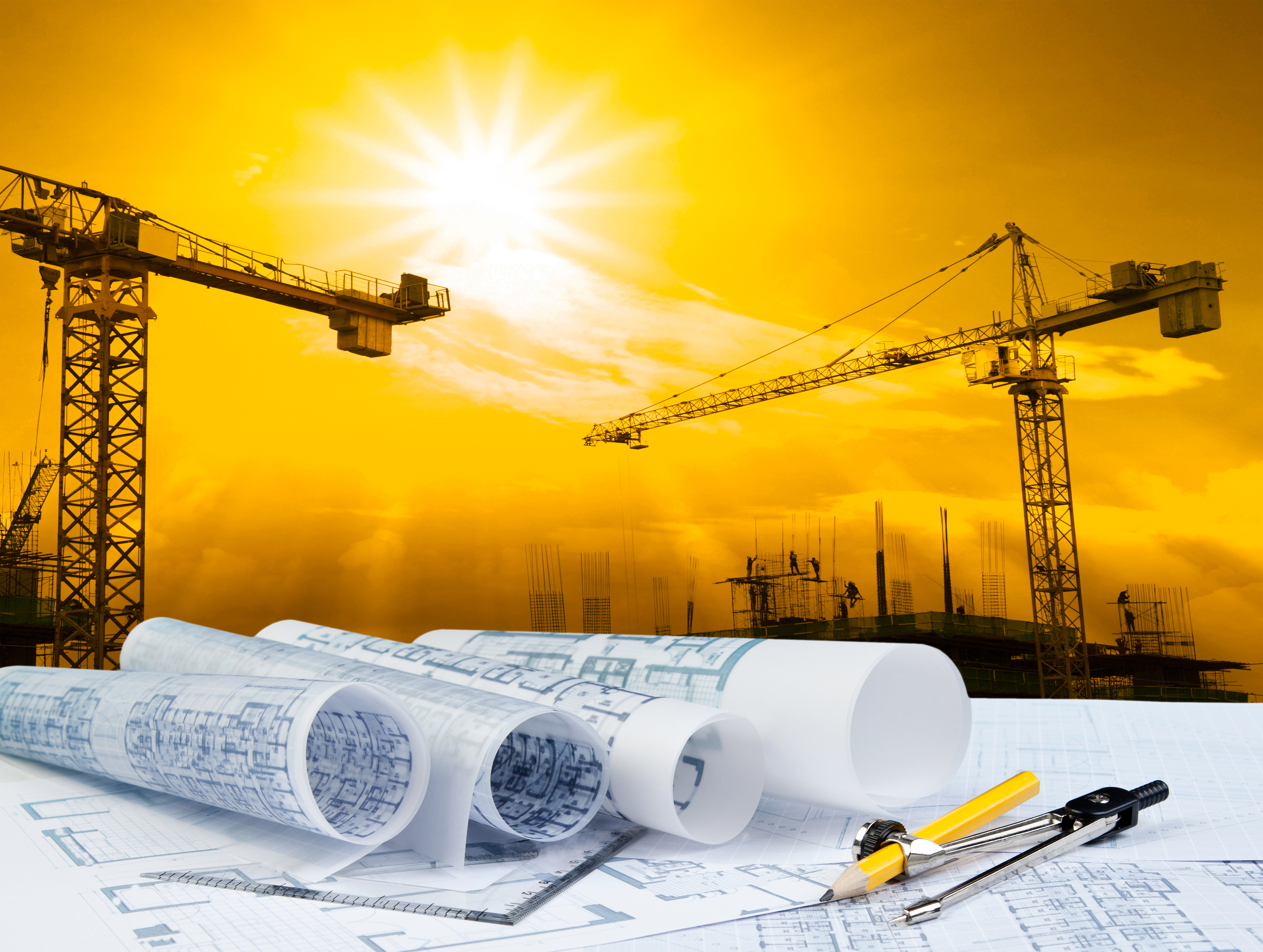 Deux grues derrière des papiers darchitecture représentant l’économie du Québec qui rebondit.