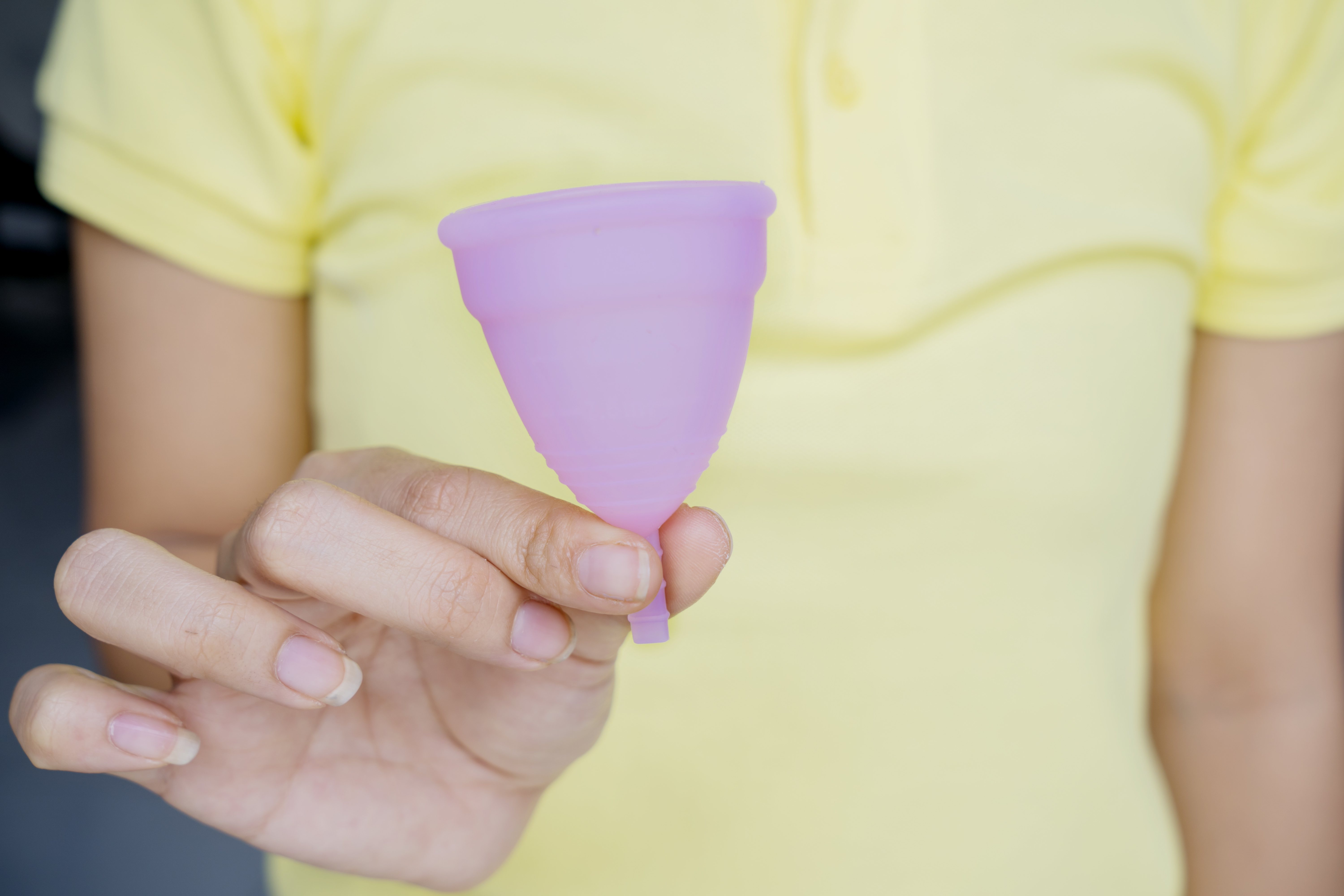 Unknown woman showing a sanitary cup