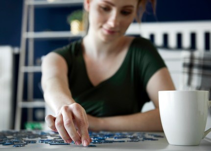 Woman spending time on doing some puzzle game