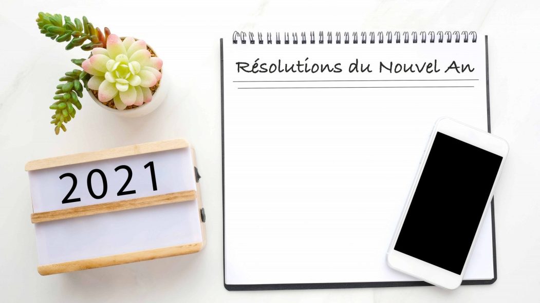 2021 resolution on blank notebook paper, smart phone with blank screen on white marble background, 2019 new year mock up, template, flat lay