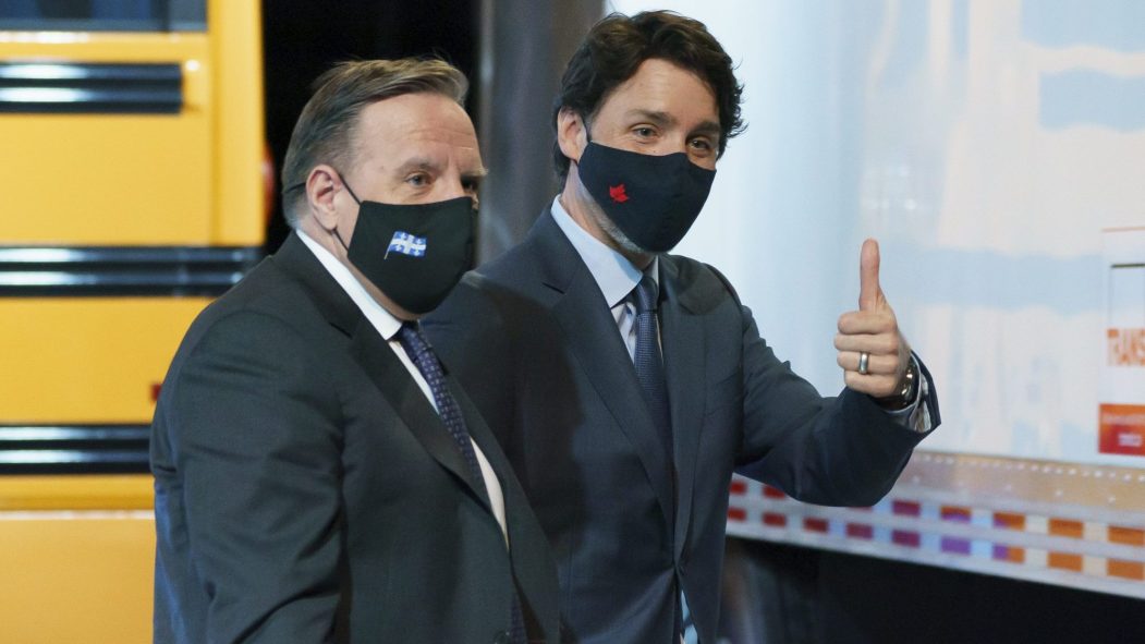 François Legault et Justin Trudeau devant un autobus jaune