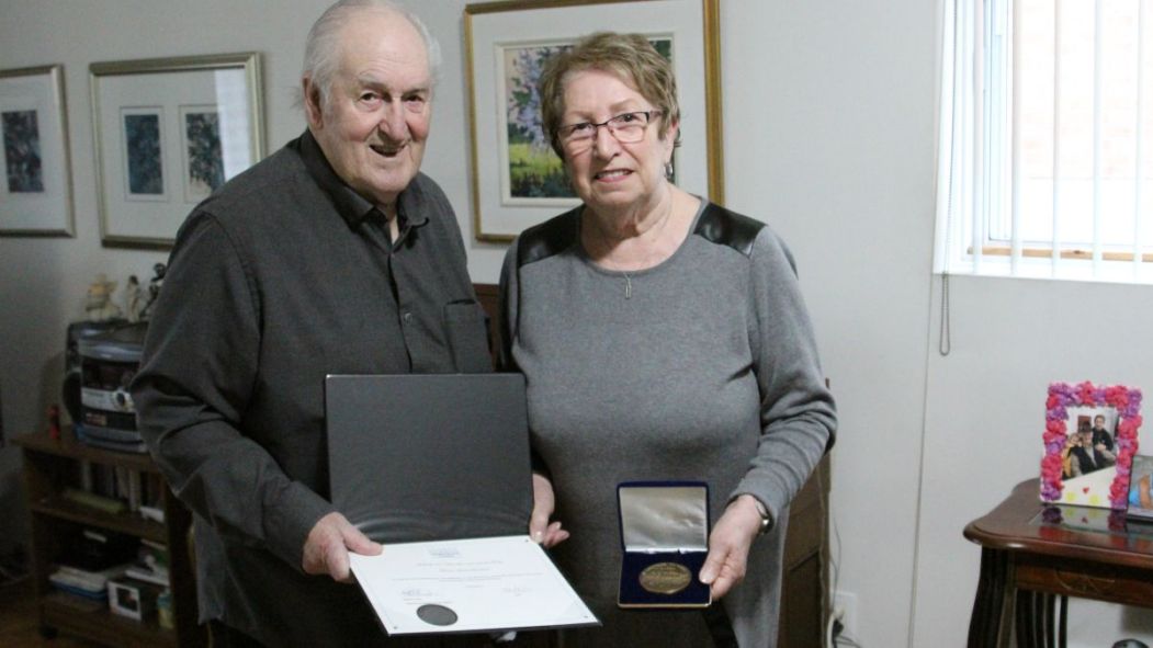 Annette Blanchard montre sa médaille de l'Assemblée nationale avec son mari, Edmond