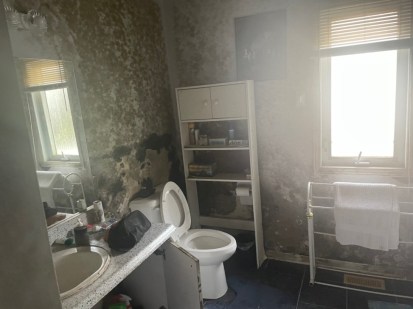 La salle de bain de la maison de Hull. Tout est couvert de moisissure.