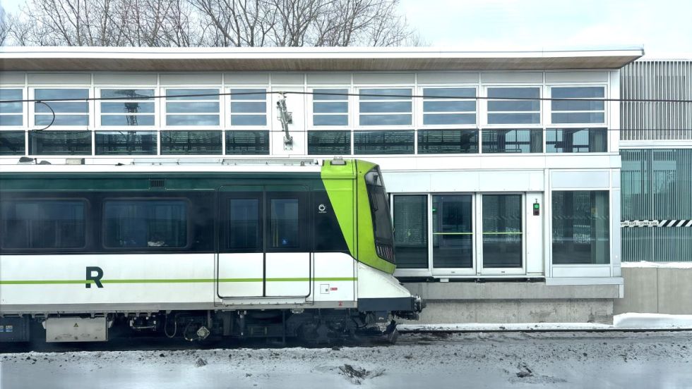 Un train du REM devant une station, en hiver.