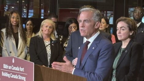 Marc Carney et Christine Fréchette devant une foule de dignitaires.