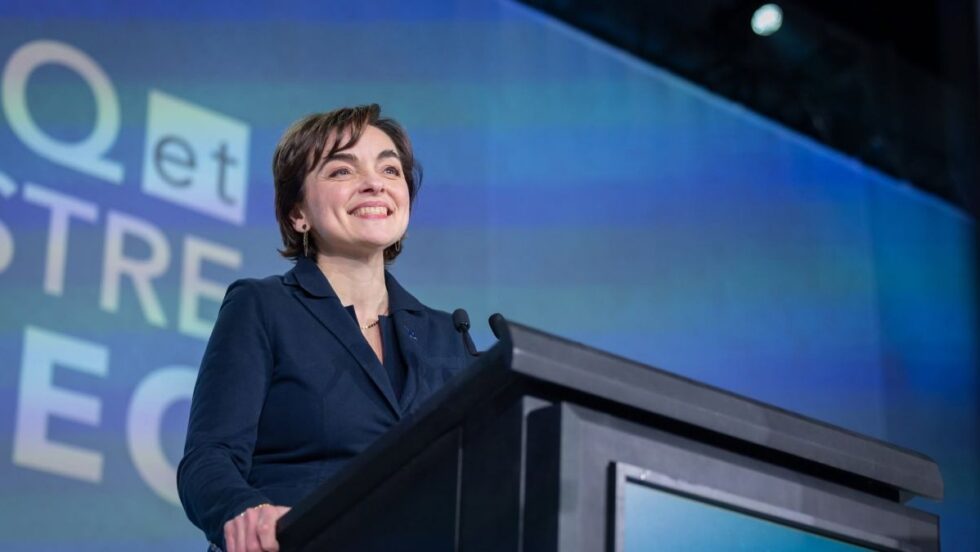 Christine Fréchette devant une pancarte électorale de la Coalition Avenir Québec.